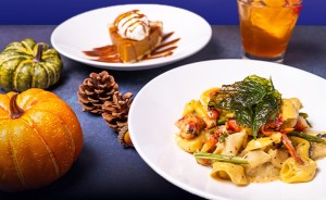 A variety of types of food with decorative pumpkins in the scene too.