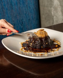 Chocolate molten cake that's about to be enjoyed at Kona Grill.