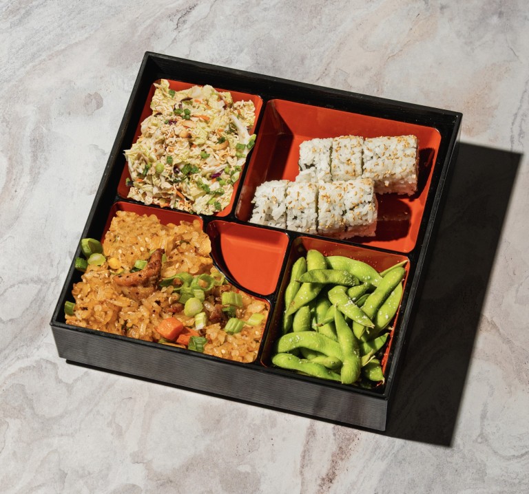 Kona Grill's Lunch Bento Box, featuring fried rice, sushi rolls, edamame and chicken.